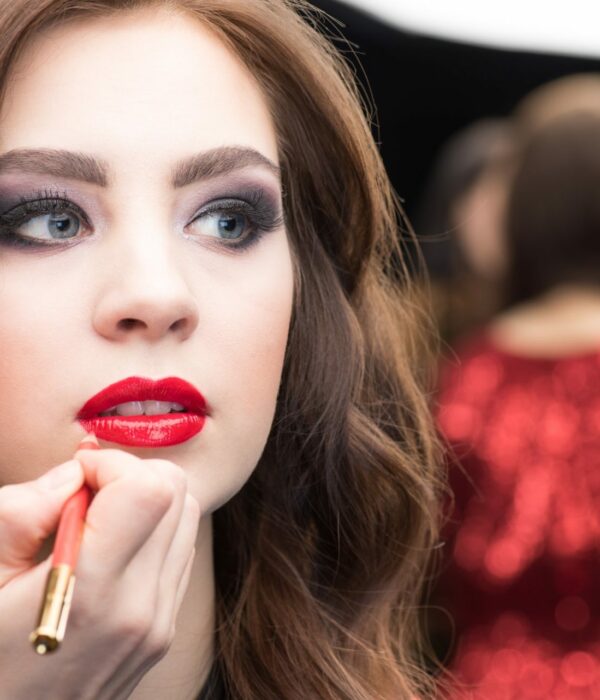 Make-up artist applying make-up to gorgeous young woman